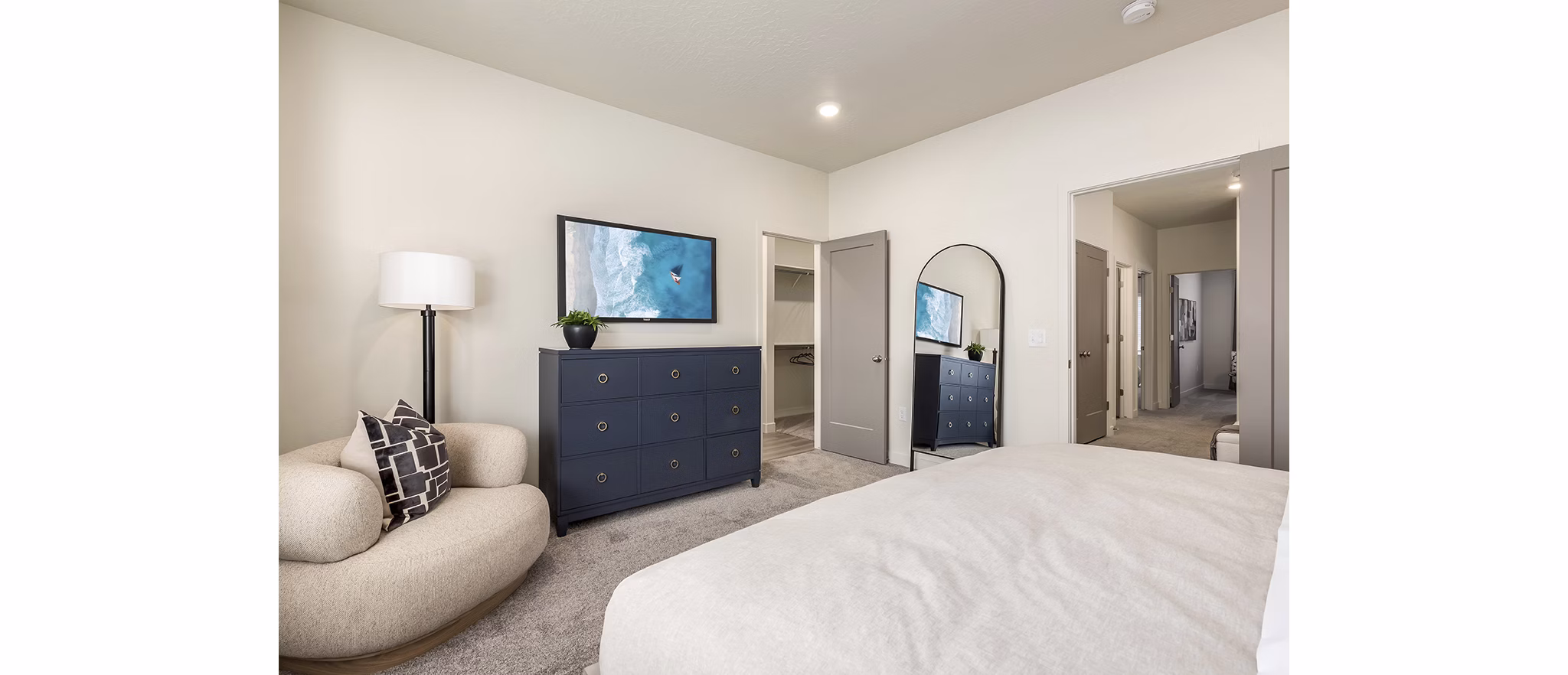 Cozy bedroom with modern furniture at H2O Townhomes Apartments