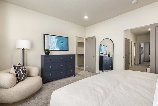 Cozy bedroom with modern furniture at H2O Townhomes Apartments