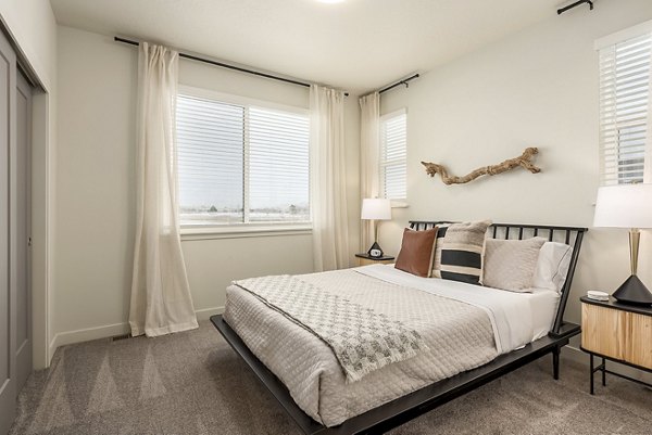 Cozy bedroom with modern furnishings in H2O Townhomes Apartments, offering comfort and style for luxury living