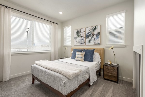 Modern bedroom with stylish decor at H2O Townhomes Apartments, offering luxury living spaces for comfort and relaxation