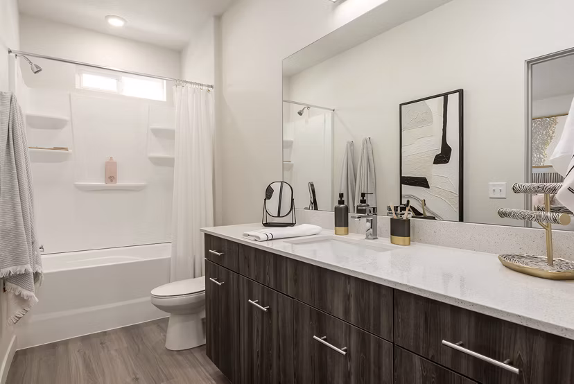 Modern bathroom with sleek fixtures and natural light at H2O Townhomes Apartments