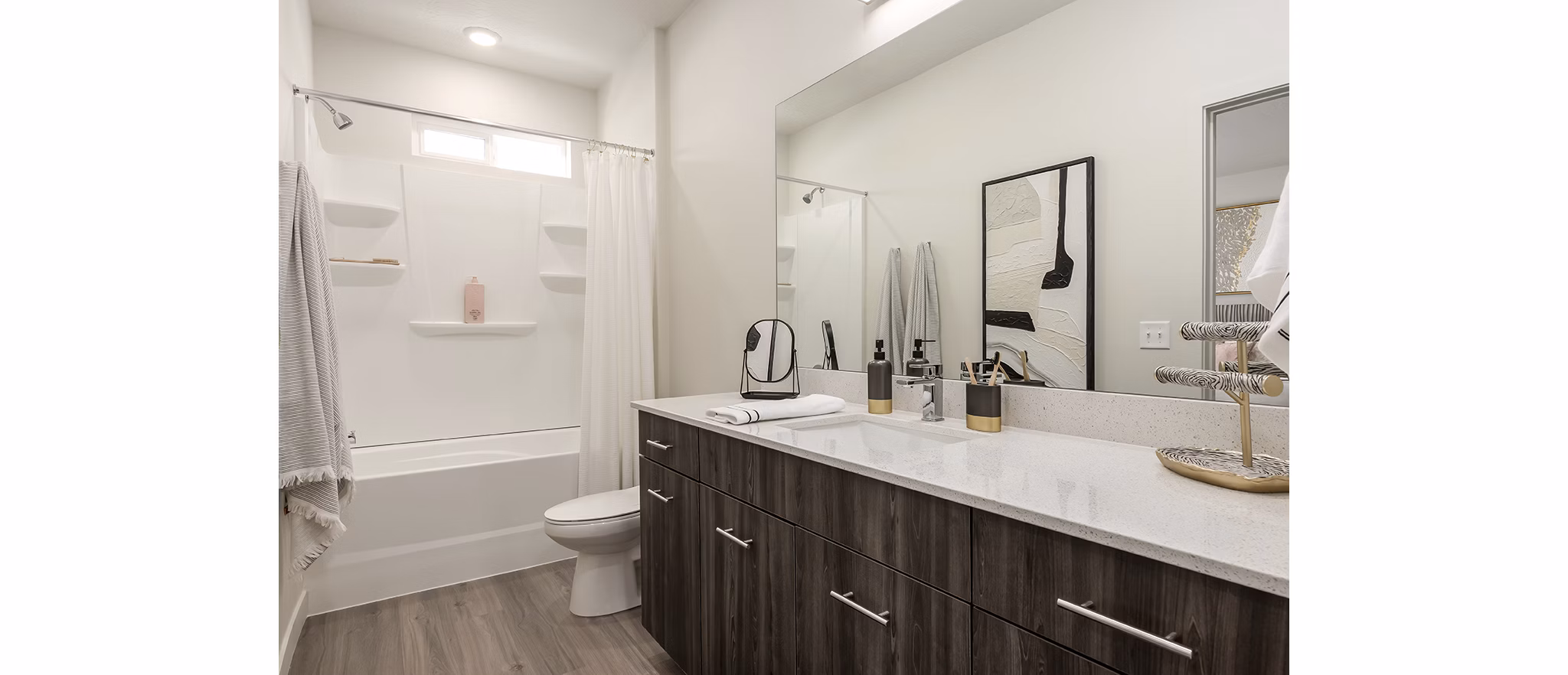 Modern bathroom with sleek fixtures and natural light at H2O Townhomes Apartments