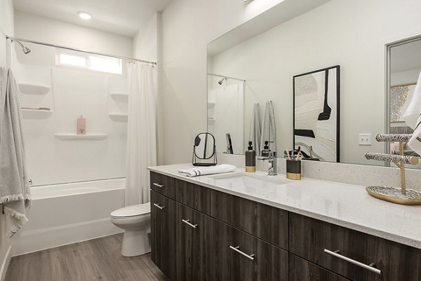 Modern bathroom with sleek fixtures and natural light at H2O Townhomes Apartments
