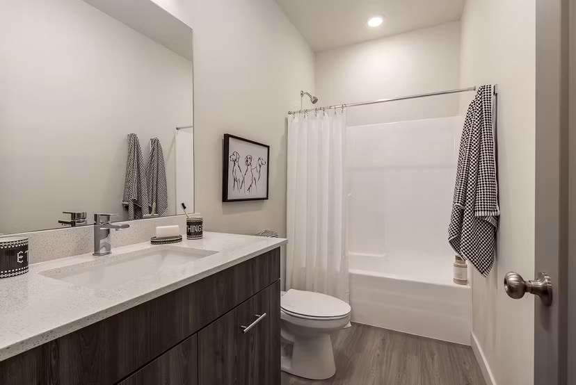 Bathroom at H2O Townhomes Apartments featuring sleek fixtures and modern design, offering a luxurious bathing experience