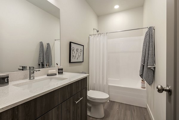 Bathroom at H2O Townhomes Apartments featuring sleek fixtures and modern design, offering a luxurious bathing experience