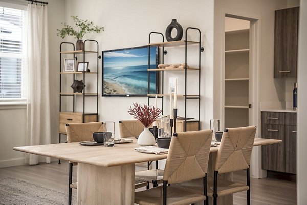 Dining area with modern decor and elegant lighting at H2O Townhomes Apartments