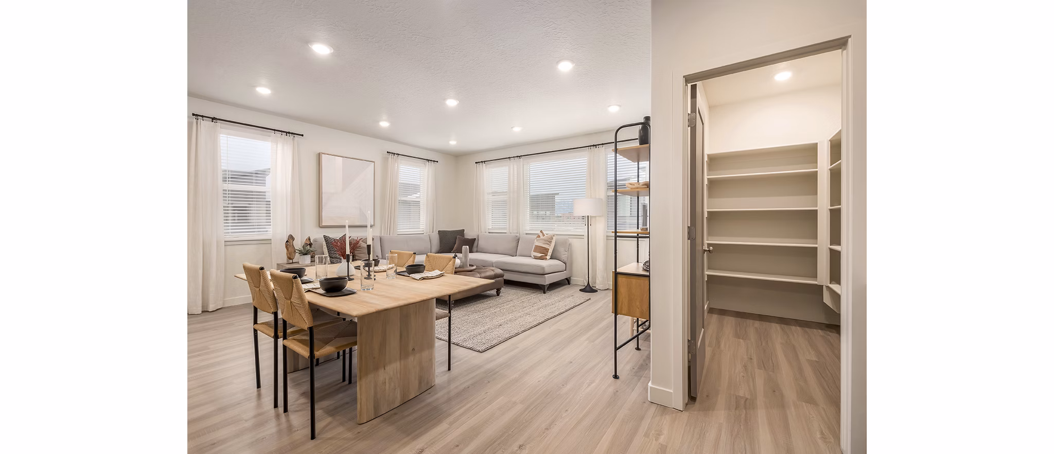 Dining area featuring modern decor and large windows at H2O Townhomes Apartments