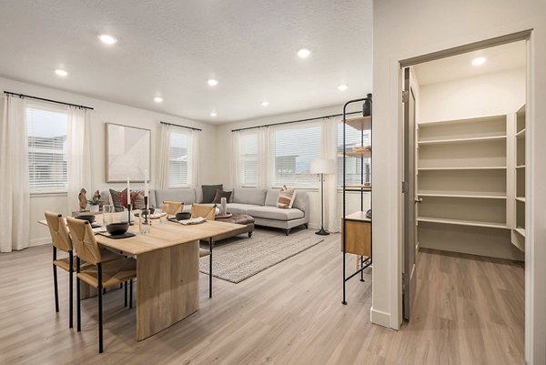 Dining area featuring modern decor and large windows at H2O Townhomes Apartments