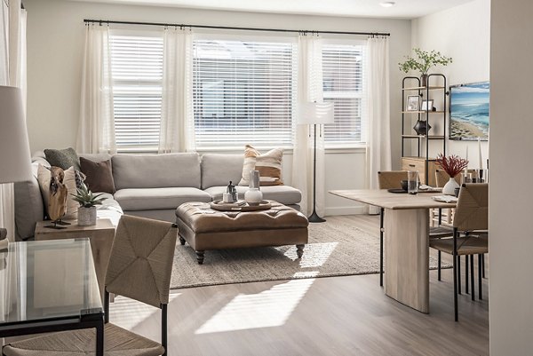 Open-plan kitchen with granite countertops and stainless steel appliances in San Fernando Building Apartments