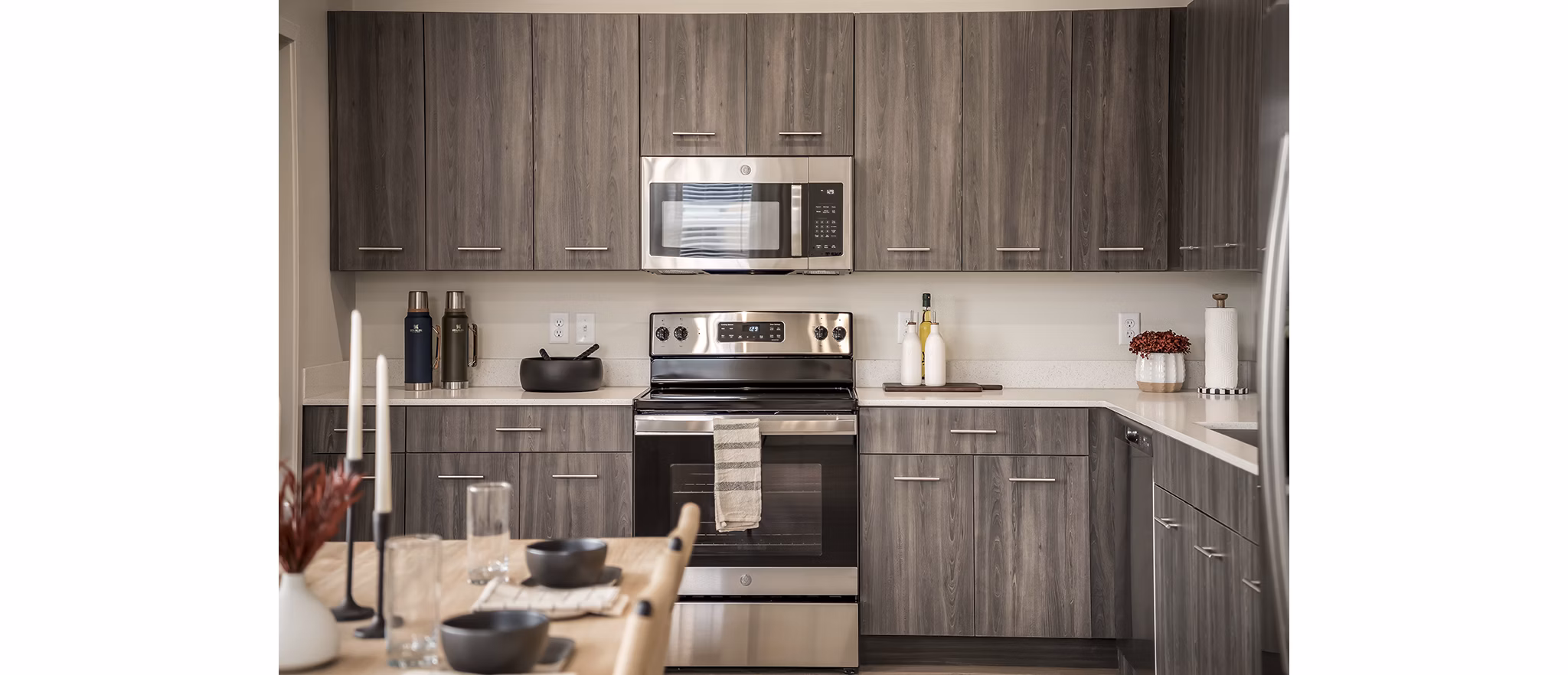 Modern kitchen with stainless steel appliances at H2O Townhomes Apartments