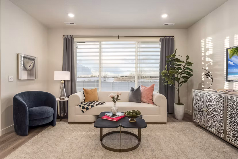 Spacious living room with modern decor and natural light in H2O Townhomes Apartments at Greystar Luxury Apartments
