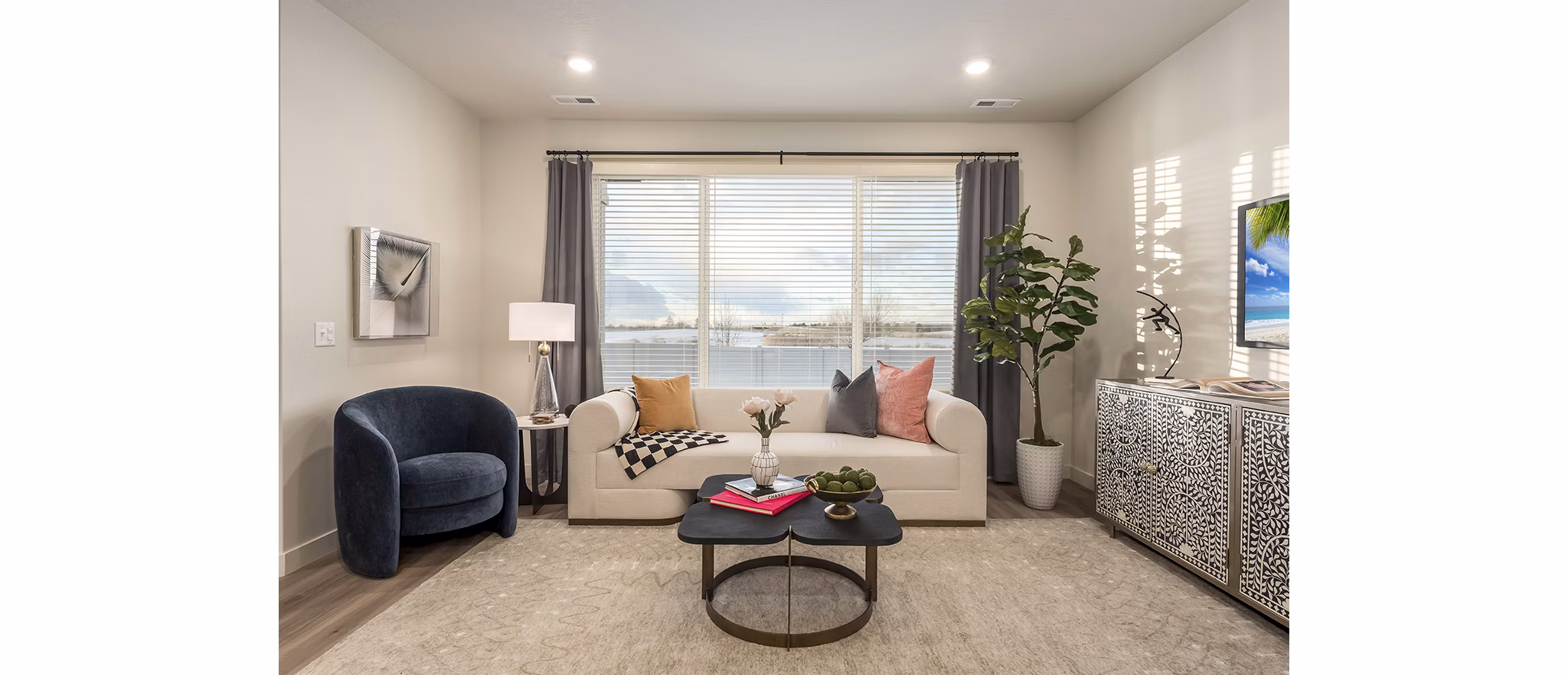 Spacious living room with modern decor and natural light in H2O Townhomes Apartments at Greystar Luxury Apartments