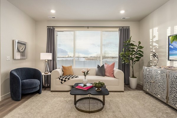 Spacious living room with modern decor and natural light in H2O Townhomes Apartments at Greystar Luxury Apartments