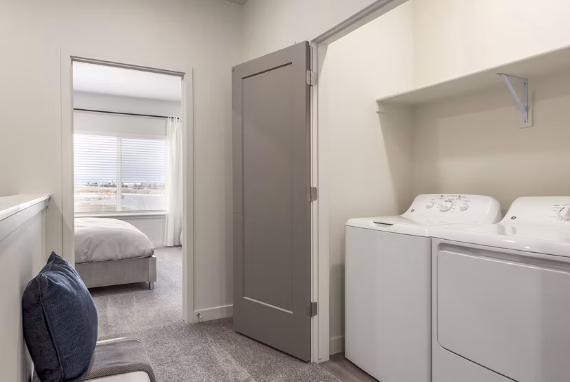Laundry room with modern appliances at H2O Townhomes Apartments, offering convenience and style in your Greystar luxury apartment experience