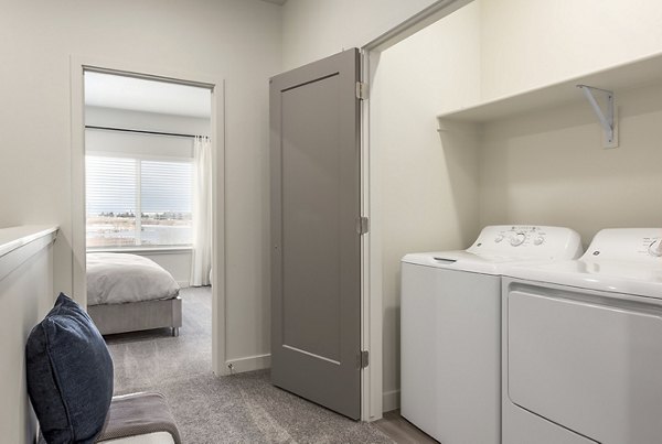 Laundry room with modern appliances at H2O Townhomes Apartments, offering convenience and style in your Greystar luxury apartment experience