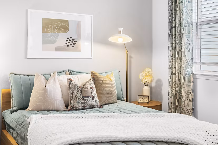 Contemporary bedroom featuring plush bedding and stylish decor at Mira Crystal Lake Apartments