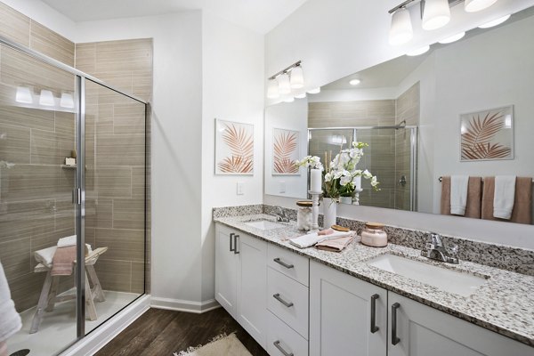 Elegant bathroom with modern fixtures and glass shower at Mira Crystal Lake Apartments