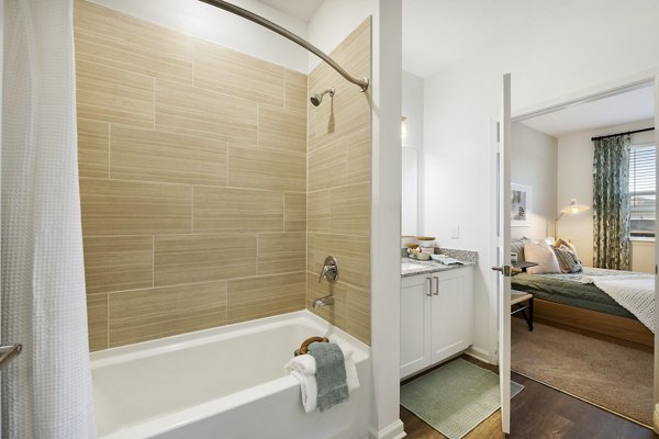 Bathroom with elegant fixtures and marble countertops at Mira Crystal Lake Apartments