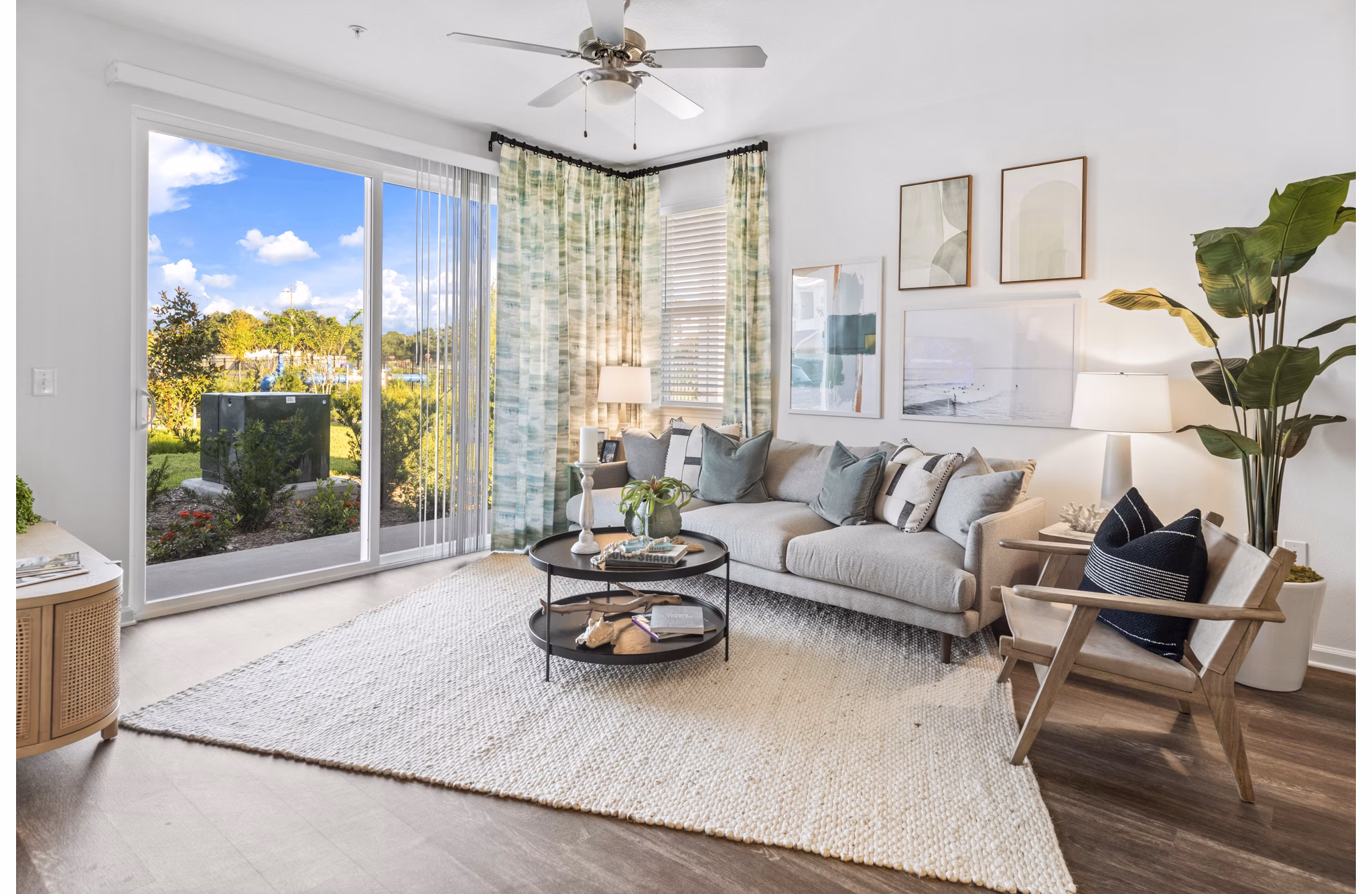 Living room with modern dÃ©cor and lake views at Mira Crystal Lake Apartments