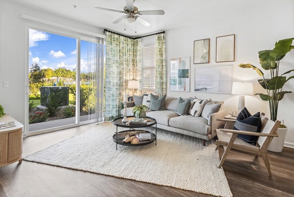 Living room with modern dÃ©cor and lake views at Mira Crystal Lake Apartments
