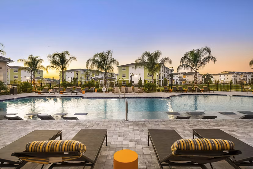 Luxurious poolside lounging at Mira Crystal Lake Apartments with scenic views
