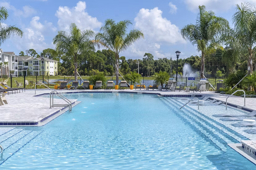 Poolside serenity at Mira Crystal Lake Apartments: luxury pool featuring cabanas and lush landscaping
