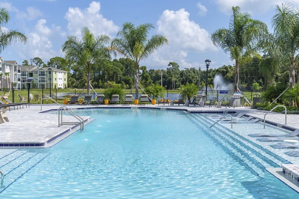 Poolside serenity at Mira Crystal Lake Apartments: luxury pool featuring cabanas and lush landscaping