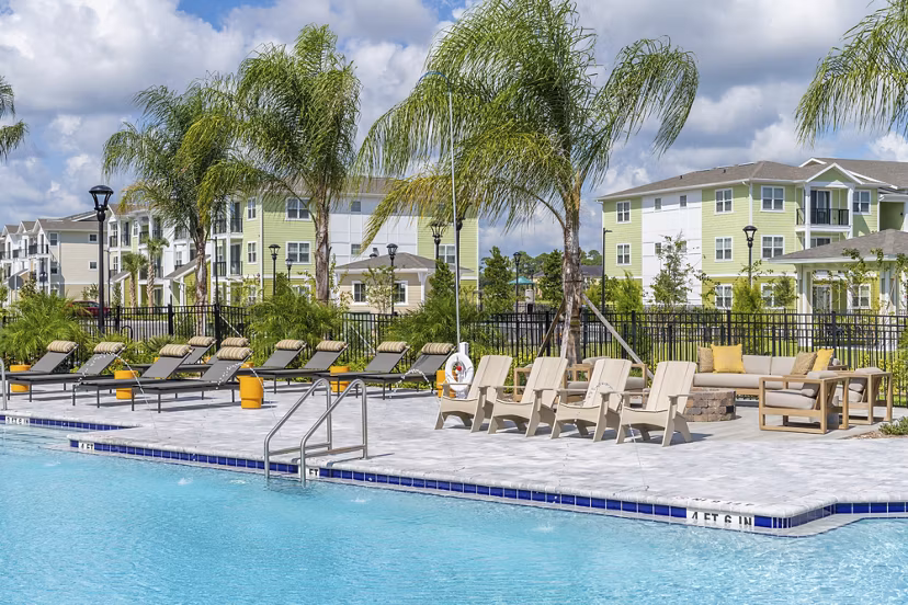 Mira Crystal Lake Apartments pool with surrounding lush landscape, offering residents a relaxing oasis in a luxury apartment community