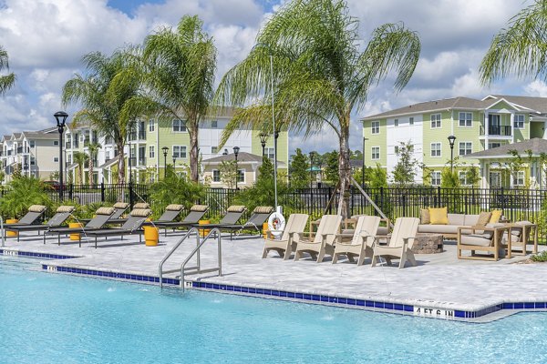 Mira Crystal Lake Apartments pool with surrounding lush landscape, offering residents a relaxing oasis in a luxury apartment community