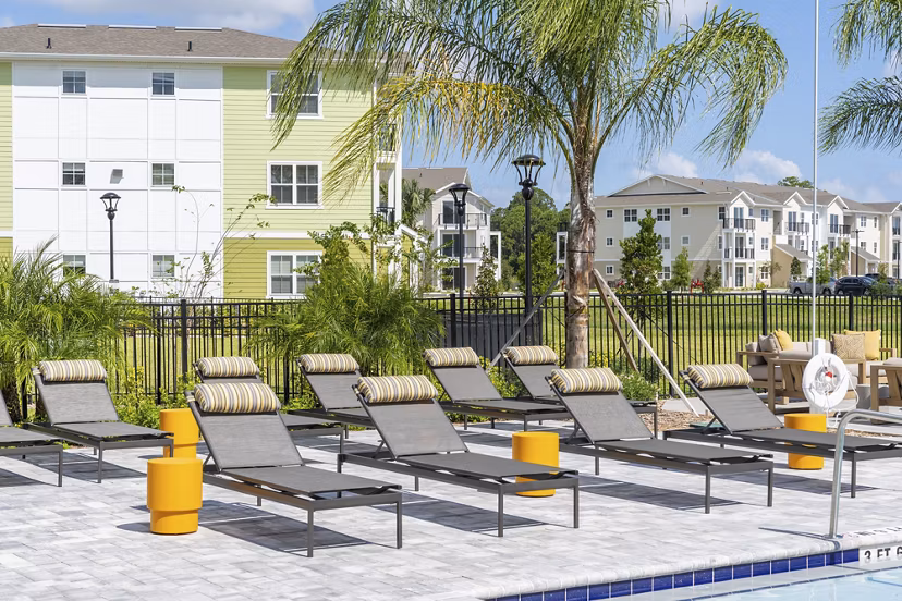 Patio with lounge seating and green views at Mira Crystal Lake Apartments