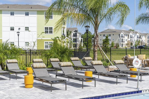 Patio with lounge seating and green views at Mira Crystal Lake Apartments