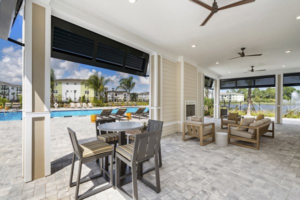 Patio with comfortable seating and garden views at Mira Crystal Lake Apartments