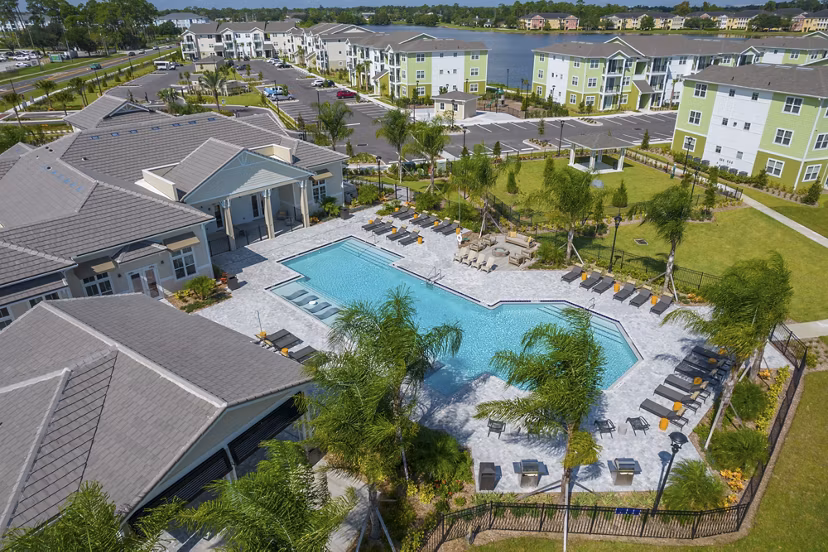 Exterior view of luxury apartments surrounded by lush landscape at Mira Crystal Lake Apartments