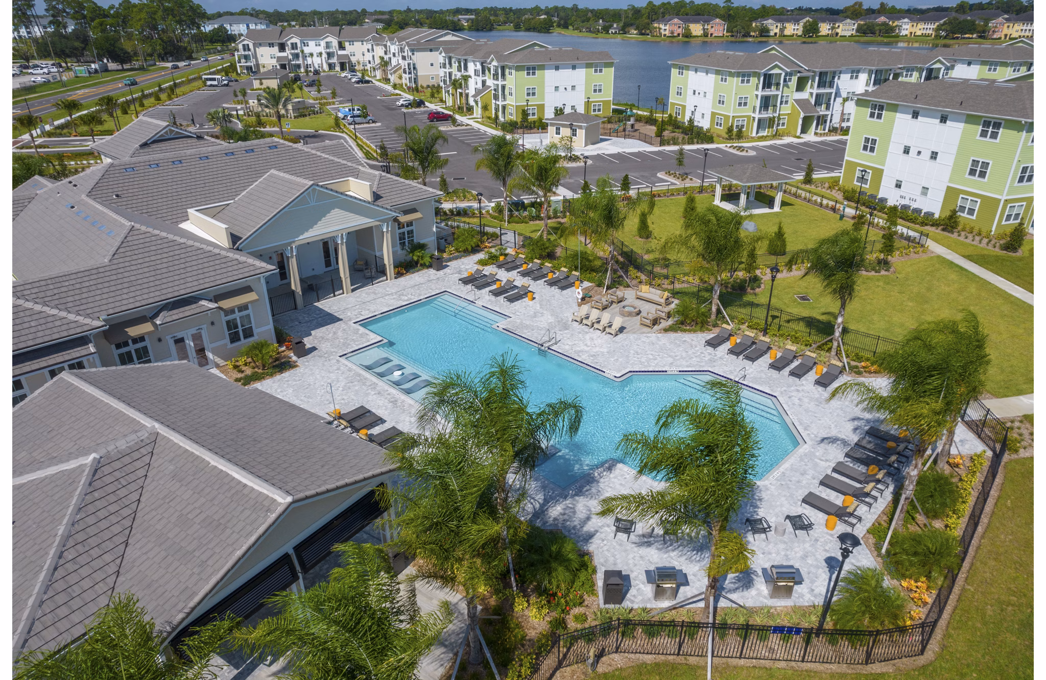 Exterior view of luxury apartments surrounded by lush landscape at Mira Crystal Lake Apartments