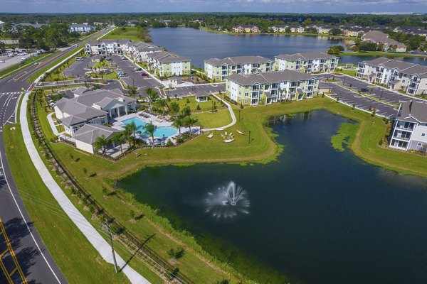 Mira Crystal Lake Apartments: Scenic view of lakeside luxury apartments in a tranquil setting