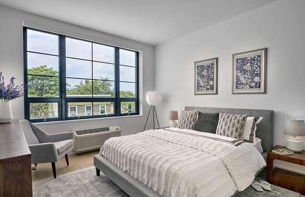 Modern bedroom with large windows at BELA Apartments