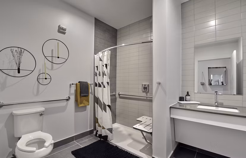Modern bathroom featuring sleek fixtures and spacious layout in BELA Apartments