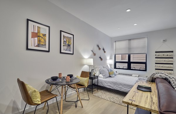 Elegant dining area with modern furnishings at BELA Apartments, offering luxury living in urban surroundings