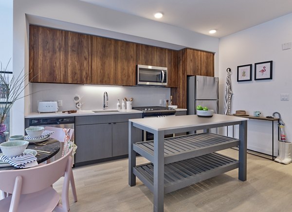 Modern kitchen with stainless steel appliances at BELA Apartments, luxury living in the heart of the community