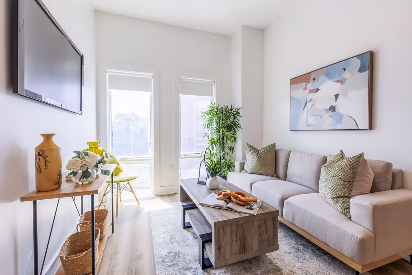 Spacious living room with modern decor and natural light at The Bedford Apartments