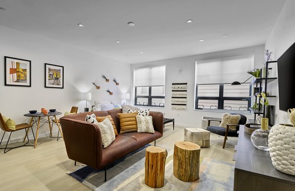 Living room with modern decor and large windows at BELA Apartments