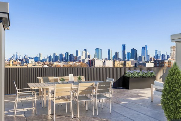 Spacious patio with seating area at The Bedford Apartments, offering outdoor relaxation in a luxury setting