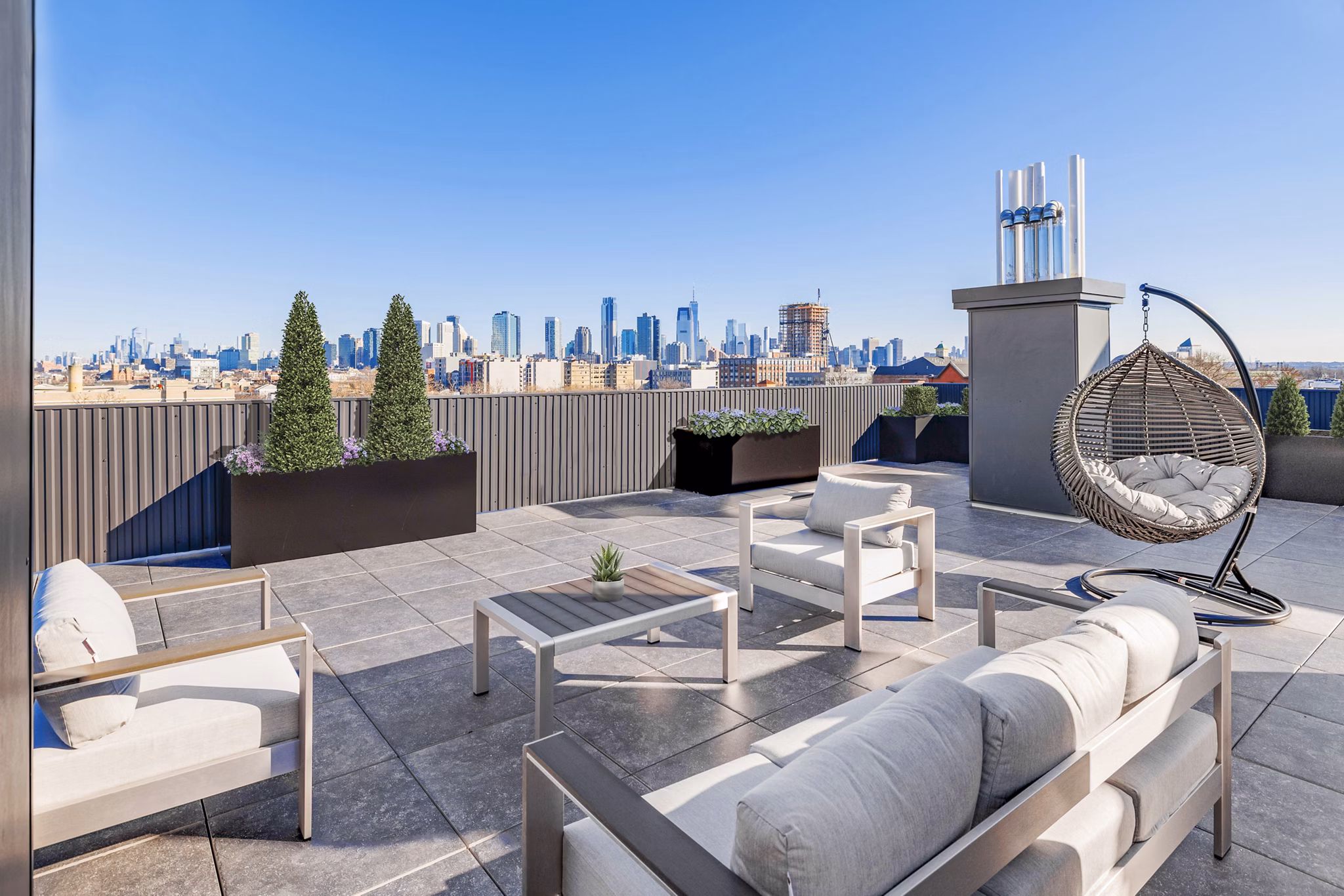 Elegant patio with stylish seating at The Bedford Apartments, ideal for entertaining and relaxation in luxury living