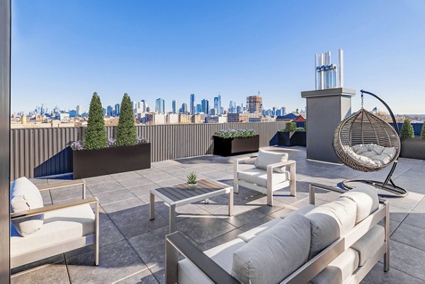 Elegant patio with stylish seating at The Bedford Apartments, ideal for entertaining and relaxation in luxury living