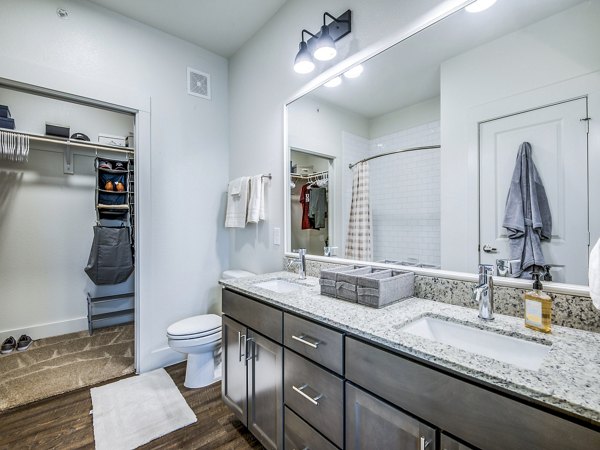 Modern bathroom featuring sleek fixtures and marble tiles at Vecina Apartment Villas
