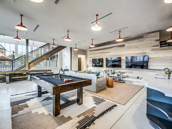 Clubhouse game room at Vecina Apartment Villas with billiards table and seating area