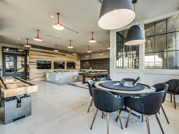 Vecina Apartment Villas: Clubhouse game room featuring billiards and lounge seating, perfect for unwinding and socializing in luxury apartments
