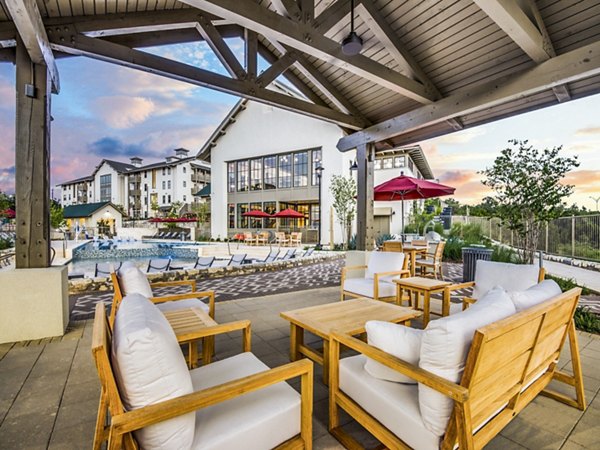 Inviting patio with outdoor seating and lush landscaping at Vecina Apartment Villas