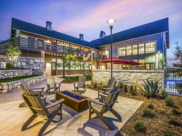 Cozy fire pit area on the patio at Vecina Apartment Villas, perfect for social gatherings and relaxation in a luxurious setting