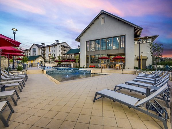 Resort-style pool at Vecina Apartment Villas with lush landscaping for luxury living